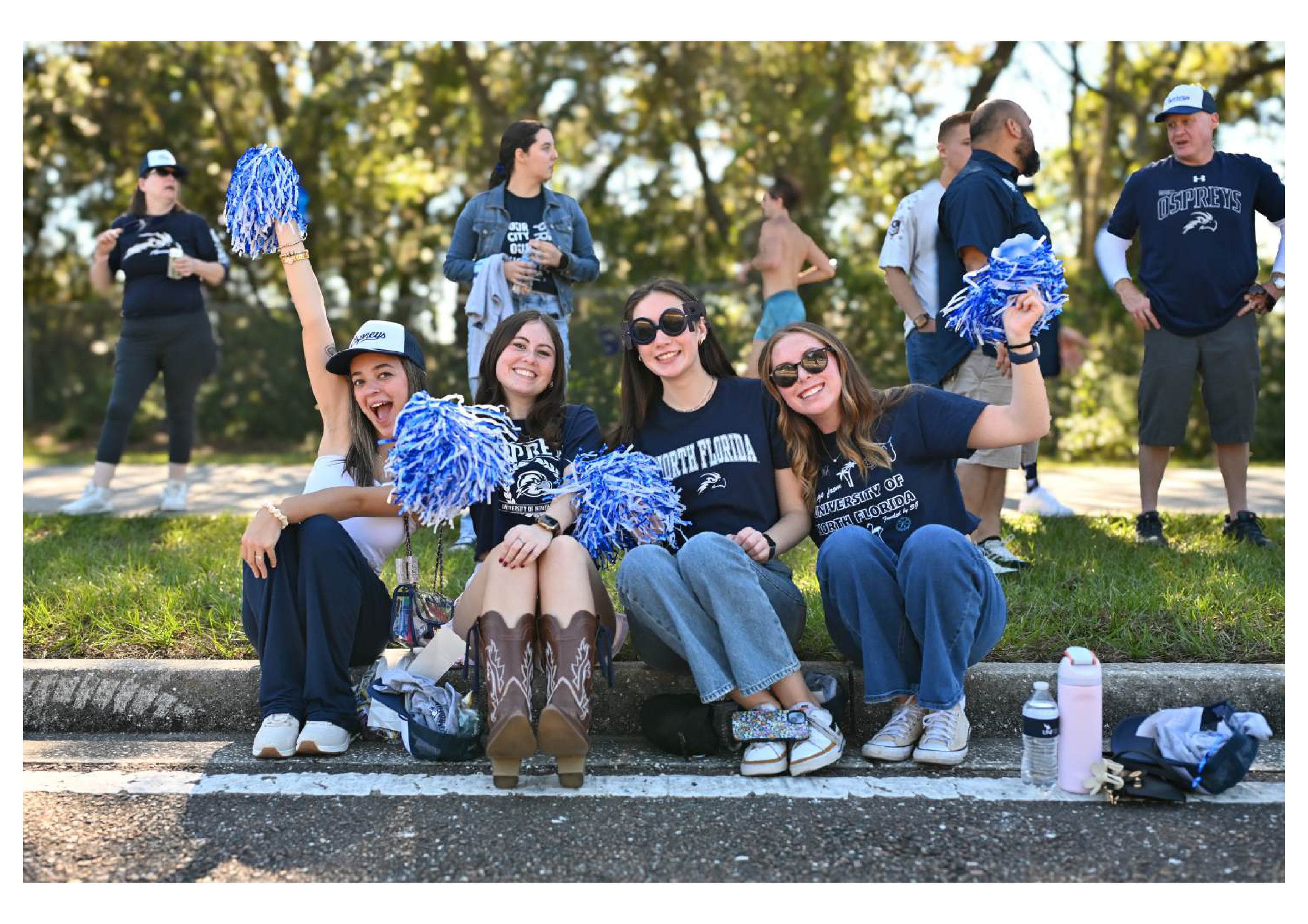 UNF students cheering at the Homecoming parade.